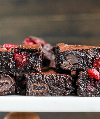 These Cranberry Brownies are made with dark chocolate, fresh and dried cranberries, and dark chocolate covered cranberries! If you love tangy cranberries, you'll love this unique brownie recipe.