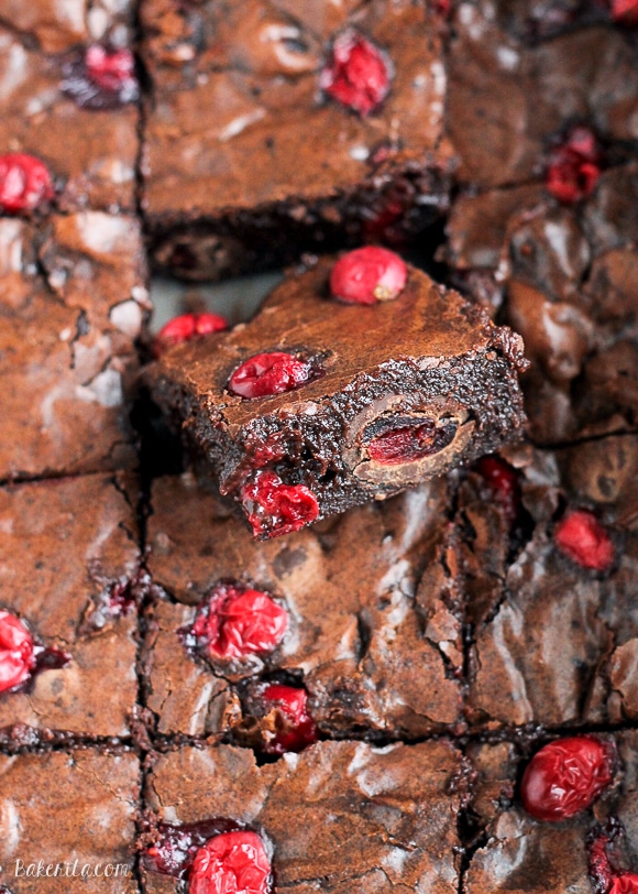 These Cranberry Brownies are made with dark chocolate, fresh and dried cranberries, and dark chocolate covered cranberries! These are the perfect addition to a holiday dessert platter.