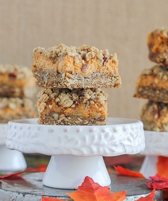 These Pumpkin Cheesecake Crumb Bars have a crumble crust full of oats and pecans with a creamy pumpkin cheesecake filling. This recipe is an irresistible fall treat!