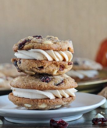 Pumpkin Spice Cookie Sandwiches with Cream Cheese Filling are easy and delicious! The pumpkin spice cookies are made even better with white chocolate and dried cranberries.