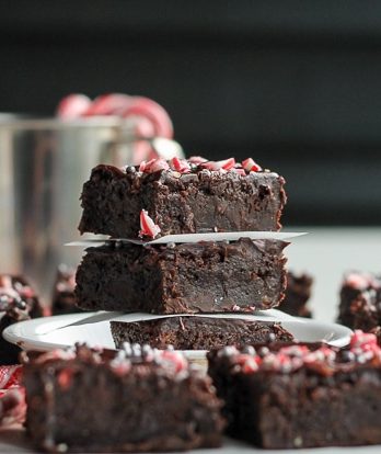 These Peppermint Brownies are classic fudge brownies with peppermint extract and mint chips for a chilly winter twist. This easy brownie recipe is topped with dark chocolate ganache and crushed candy canes.