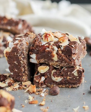These Chocolate Hazelnut Magic Bars are a new flavor twist on a classic cookie bar. The crust is kept naturally gluten-free with hazelnut flour. A gooey Nutella filling and topping made of chocolate chips, flaked coconut, and hazelnuts takes these bars over the top!
