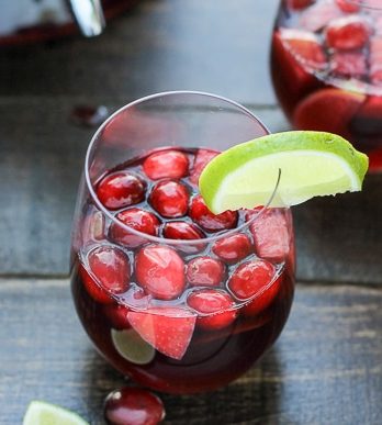 This Cranberry Lime Sangria is a sparkling + festive take on sangria! This is the perfect refreshing cocktail for a crowd.