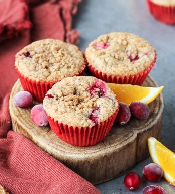 These Cranberry Orange Muffins are bursting with tart cranberries + orange zest and topped with a sweet crumble - you'd never guess that they're vegan!