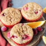 These Cranberry Orange Muffins are bursting with tart cranberries + orange zest and topped with a sweet crumble - you'd never guess that they're vegan!