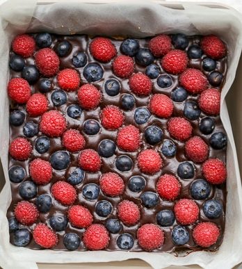 These Chocolate Berry Bars have an almond flour crust topped with vegan chocolate ganache and fresh raspberries and blueberries. These dessert bars are beautiful, delicious, and better for you - they're gluten-free, vegan, refined sugar-free, and Paleo.