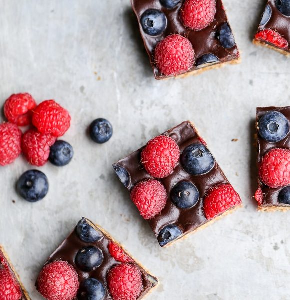 These Chocolate Berry Bars have an almond flour crust topped with vegan chocolate ganache and fresh raspberries and blueberries. These dessert bars are beautiful, delicious, and better for you - they're gluten-free, vegan, refined sugar-free, and Paleo.