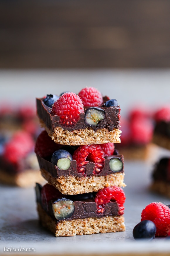 These Chocolate Berry Bars have an almond flour crust topped with vegan chocolate ganache and fresh raspberries and blueberries. These dessert bars are beautiful, delicious, and better for you - they're gluten-free, vegan, refined sugar-free, and Paleo.