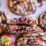 These Chocolate-Dipped Strawberry Chocolate Chip Cookies are soft + chewy cookies full of freeze dried strawberries and chocolate chunks, dipped and drizzled with dark chocolate.