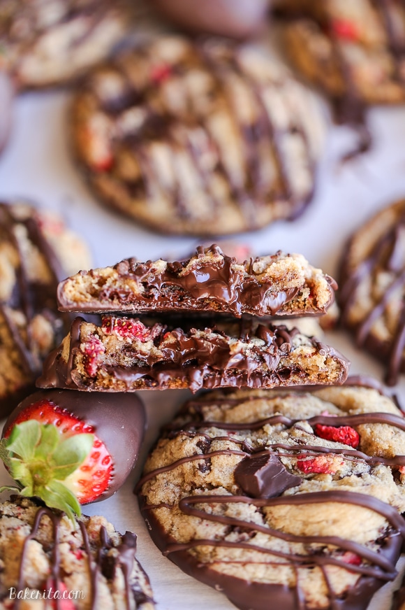 These Chocolate-Dipped Strawberry Chocolate Chip Cookies are soft + chewy cookies full of freeze dried strawberries and chocolate chunks, dipped and drizzled with dark chocolate.