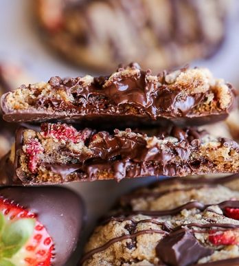 These Chocolate-Dipped Strawberry Chocolate Chip Cookies are soft + chewy cookies full of freeze dried strawberries and chocolate chunks, dipped and drizzled with dark chocolate.