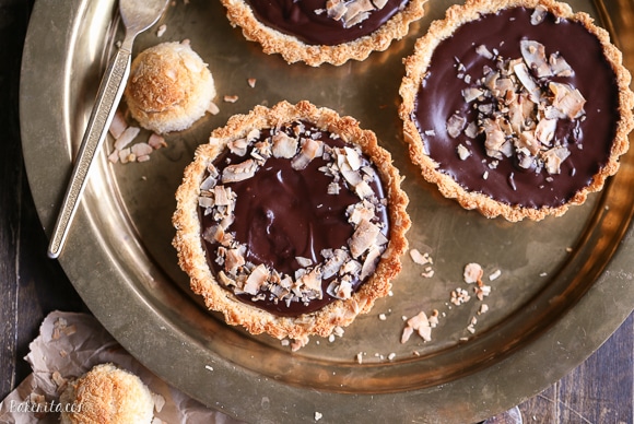 These Chocolate Ganache Tarts with Coconut Macaroon Crust are Paleo, gluten-free + refined sugar free, but you'd never guess from the decadent vegan chocolate ganache or sweet and chewy crust.