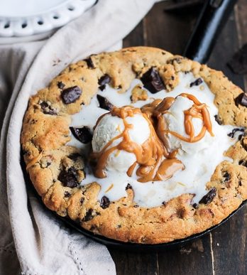 This Peanut Butter Chocolate Chip Skillet Cookie is a peanut butter lover's dream!! The peanut butter cookie stays soft in the center while the edges get crispy, and a layer of peanut butter in the center takes this skillet cookie over the top.