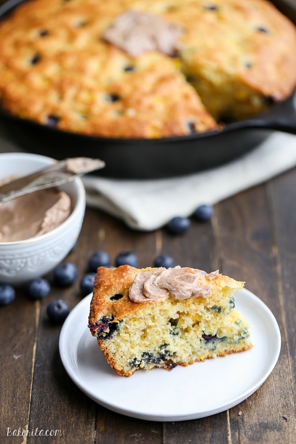 This Blueberry Cornbread is a sweeter take on traditional cornbread with fresh blueberries and sweet corn kernels. It's baked in a skillet and served with whipped cinnamon honey butter.