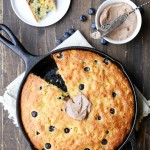 This Blueberry Cornbread is a sweeter take on traditional cornbread with fresh blueberries and sweet corn kernels. It's baked in a skillet and served with whipped cinnamon honey butter.