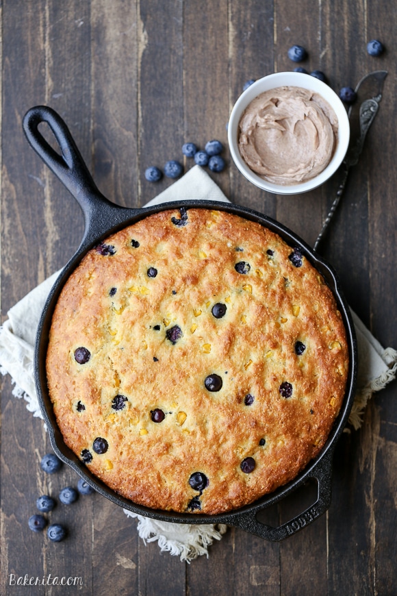 This Blueberry Cornbread is a sweeter take on traditional cornbread with fresh blueberries and sweet corn kernels. It's baked in a skillet and served with whipped cinnamon honey butter.