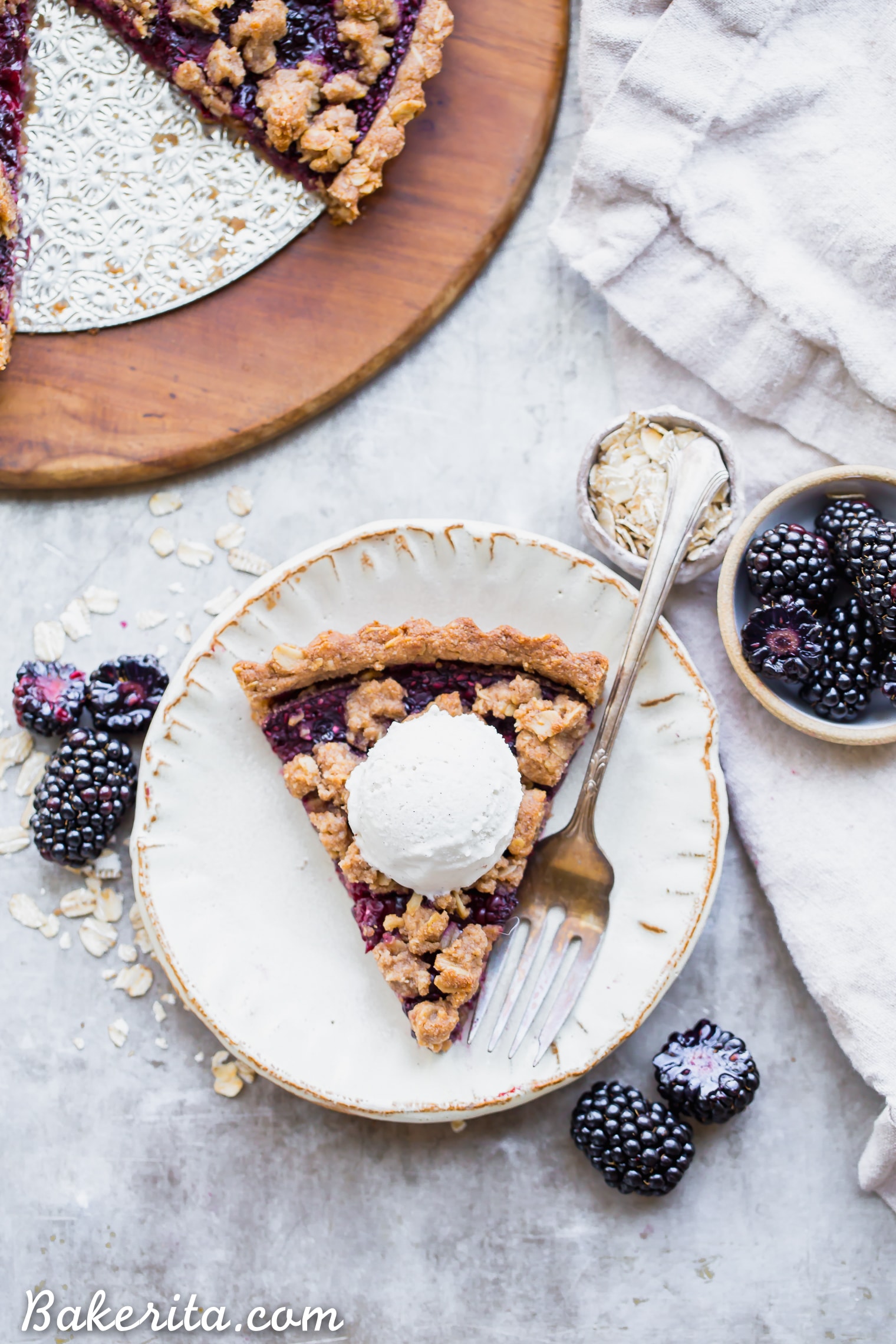 This quick and easy Blackberry Crisp Tart has an oatmeal crust, a layer of quick blackberry chia jam, and fresh blackberries! It's perfect with vanilla ice cream. This simple recipe is gluten-free, refined sugar-free and vegan.