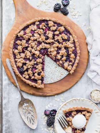 This quick and easy Blackberry Crisp Tart has an oatmeal crust, a layer of quick blackberry chia jam, and fresh blackberries! It's perfect with vanilla ice cream. This simple recipe is gluten-free, refined sugar-free and vegan.