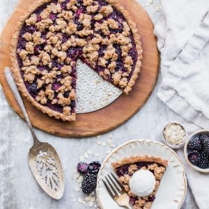 This quick and easy Blackberry Crisp Tart has an oatmeal crust, a layer of quick blackberry chia jam, and fresh blackberries! It's perfect with vanilla ice cream. This simple recipe is gluten-free, refined sugar-free and vegan.