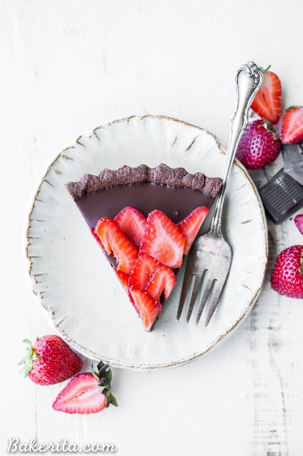 This Strawberry Chocolate Tart is filled with vegan chocolate ganache and topped with fresh strawberries, all in a chocolate crust. Slice into this easy and delicious gluten-free, Paleo, and vegan dessert.