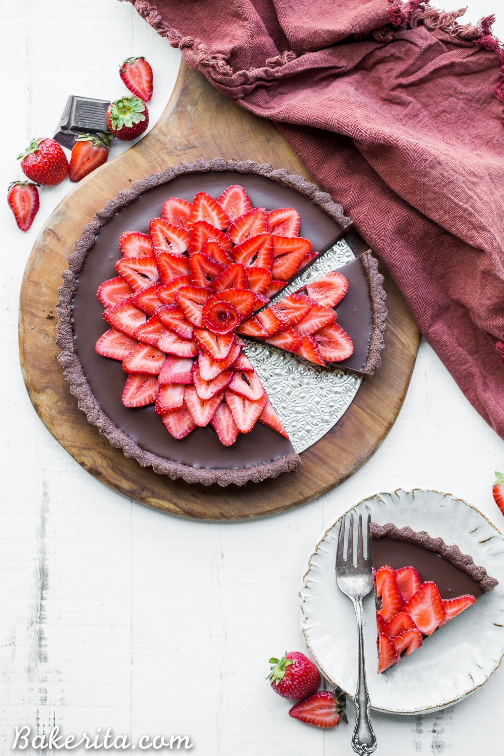 This Strawberry Chocolate Tart is filled with vegan chocolate ganache and topped with fresh strawberries, all in a chocolate crust. Slice into this easy and delicious gluten-free, Paleo, and vegan dessert.