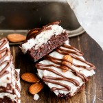 These Almond Joy Brownies have a coconut butter topping and a drizzle of dark chocolate - you'd never guess that these indulgent brownies are gluten-free, refined sugar-free, and Paleo!