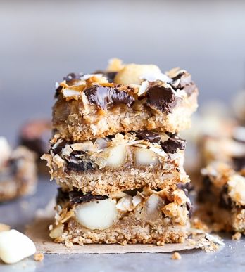 These Dark Chocolate Macadamia Nut Magic Bars are a sweet & gooey dessert bar with a hint of tropical flair. You'll be hooked after one bite of the gooey vegan caramel and buttery macadamia nuts on a gluten-free coconut lime crust.