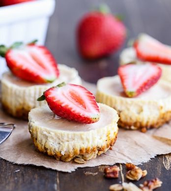 These Greek Yogurt Cheesecakes are smooth and creamy with a bit of tanginess and a crunchy granola crust. These gluten-free cheesecakes were delicious for breakfast topped with fresh berries, and they're only 177 calories each!