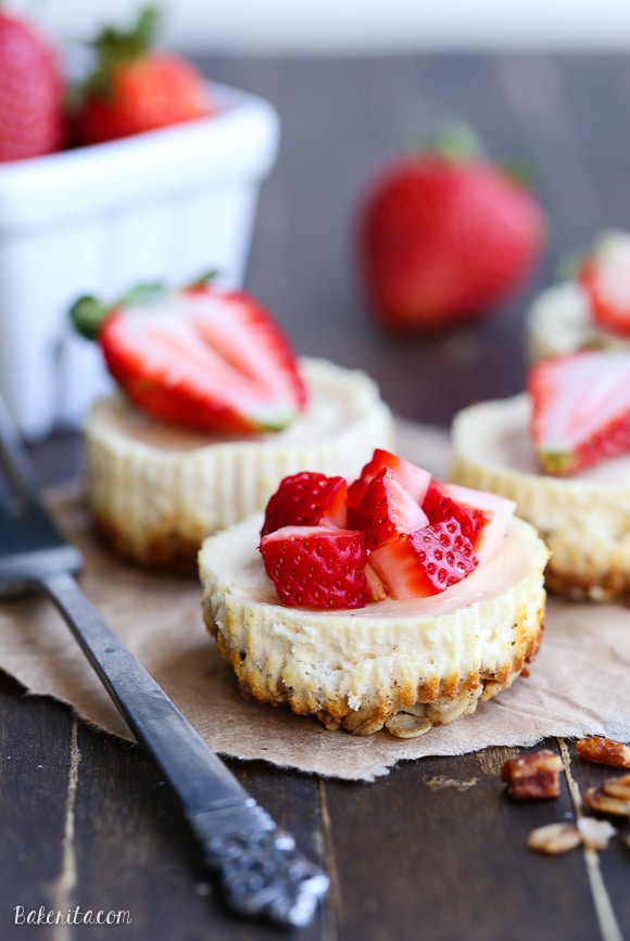 These Greek Yogurt Cheesecakes are smooth and creamy with a bit of tanginess and a crunchy granola crust. These gluten-free cheesecakes were delicious for breakfast topped with fresh berries, and they're only 177 calories each!