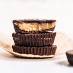These Vegan Chocolate Peanut Butter Caramel Cups are made with homemade chocolate surrounding a gooey vegan peanut butter caramel. The six-ingredient recipe for these refined sugar-free treats is the perfect way to get your candy fix!