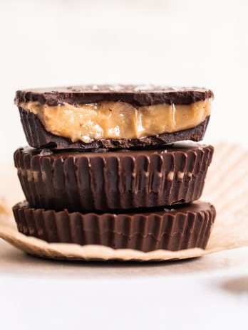 These Vegan Chocolate Peanut Butter Caramel Cups are made with homemade chocolate surrounding a gooey vegan peanut butter caramel. The six-ingredient recipe for these refined sugar-free treats is the perfect way to get your candy fix!