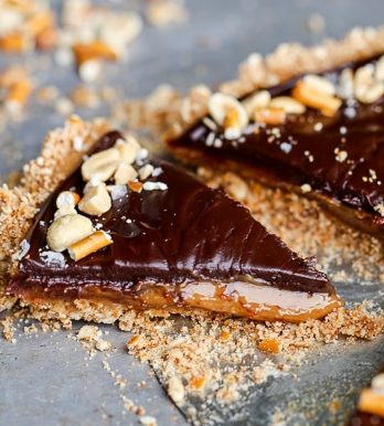 This Chocolate Peanut Butter Tart has a crunchy pretzel crust and smooth peanut butter caramel filling, all topped with luscious chocolate ganache. This recipe is gluten-free and vegan.