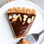 This Chocolate Peanut Butter Tart has a crunchy pretzel crust and smooth peanut butter caramel filling, all topped with luscious chocolate ganache. This recipe is gluten-free and vegan.