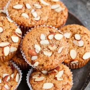 Take advantage of rhubarb's limited season with these Vegan Rhubarb Muffins! These fluffy muffins are refined sugar free and topped with crunchy sliced almonds.