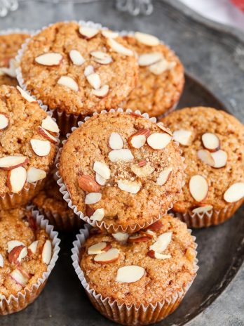Take advantage of rhubarb's limited season with these Vegan Rhubarb Muffins! These fluffy muffins are refined sugar free and topped with crunchy sliced almonds.