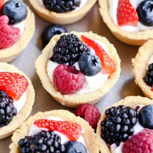 These Mini Berry Tarts have a shortbread crust with coconut cream filling and fresh berries! These sweet dessert bites are Paleo, gluten-free, and vegan.