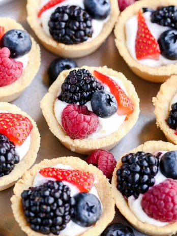 These Mini Berry Tarts have a shortbread crust with coconut cream filling and fresh berries! These sweet dessert bites are Paleo, gluten-free, and vegan.