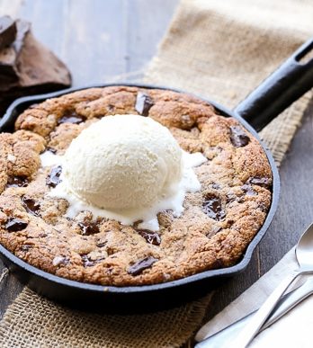 This Paleo Chocolate Chip Skillet Cookie is the ultimate gooey dessert! This gluten free and refined sugar free skillet cookie is a healthier alternative to the classic Pizookie. Use big chocolate chunks to make it extra chocolatey!