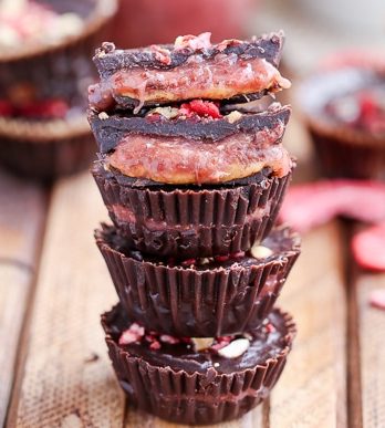 These Chocolate Peanut Butter & Jelly Cups are homemade peanut butter cups with an added layer of jam or jelly! This healthier candy recipe is only 5 ingredients, and uses an easy refined sugar free chocolate recipe.