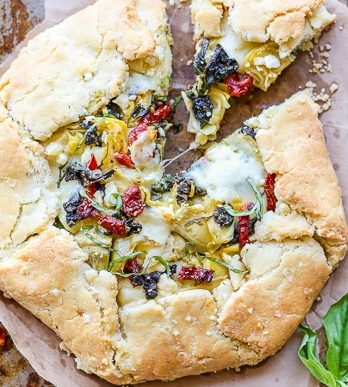 This Spinach + Artichoke Mediterranean Galette has sun-dried tomatoes, artichoke hearts, feta cheese, and gooey mozzarella tucked into a flaky gluten-free and grain-free crust. Pair with a side salad for the perfect lunch or dinner.