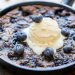 This Blueberry Skillet Cookie is a cross between a gooey skillet cookie and a bubbly blueberry cobbler! This recipe is gluten-free, Paleo and refined sugar free and makes just enough to share.