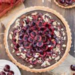 This Chocolate Cherry Tart has a toasted almond shortbread crust filled with silky chocolate ganache and fresh cherries! This gluten-free, Paleo, and vegan dessert is incredibly rich and comes together quickly.