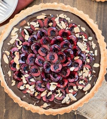 This Chocolate Cherry Tart has a toasted almond shortbread crust filled with silky chocolate ganache and fresh cherries! This gluten-free, Paleo, and vegan dessert is incredibly rich and comes together quickly.