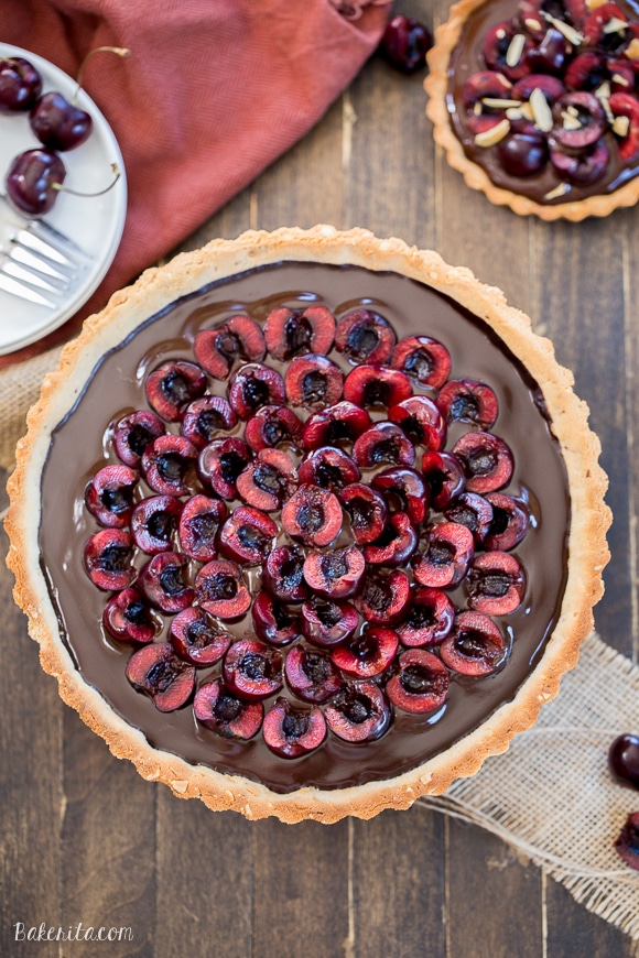 This Chocolate Cherry Tart has a toasted almond shortbread crust filled with silky chocolate ganache and fresh cherries! This gluten-free, Paleo, and vegan dessert is incredibly rich and comes together quickly.