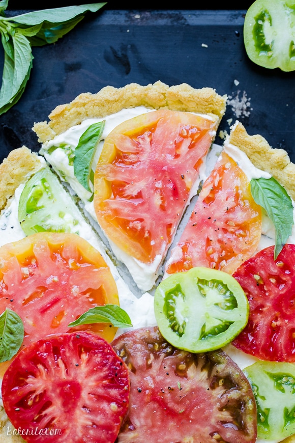 This Ricotta Heirloom Tomato Tart has a gluten-free cornmeal crust and basil ricotta filling, topped with beautiful heirloom tomatoes! This simple tart makes a wonderful appetizer, lunch, or dinner.