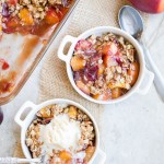 This Summer Stone Fruit Crisp features lightly sweetened peaches, plums, and nectarines topped with a oatmeal pecan crumble topping. This gluten-free and vegan dessert showcases the best of summer!