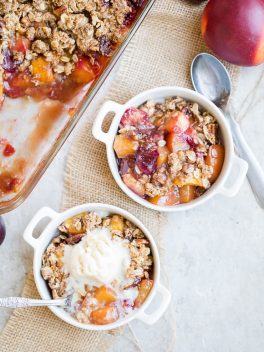 This Summer Stone Fruit Crisp features lightly sweetened peaches, plums, and nectarines topped with a oatmeal pecan crumble topping. This gluten-free and vegan dessert showcases the best of summer!