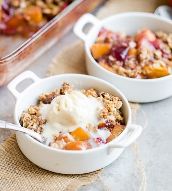 This Summer Stone Fruit Crisp features lightly sweetened peaches, plums, and nectarines topped with a oatmeal pecan crumble topping. This gluten-free and vegan dessert showcases the best of summer!