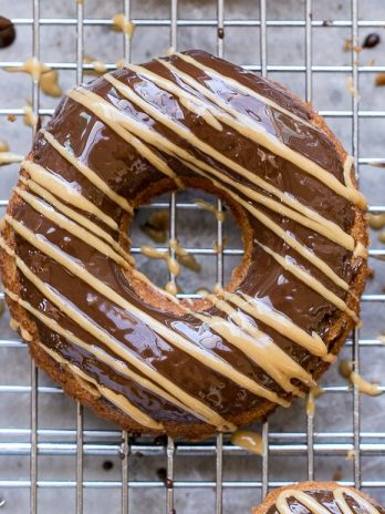These Peanut Butter Banana Donuts have a dark chocolate glaze topped with a drizzle of peanut butter! They're baked instead of fried, and they are gluten-free, refined sugar-free, and vegan, making them way healthier than your average donut.