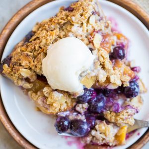 This Blueberry Nectarine Pie is the epitome of summer, and it has a delicious oatmeal almond crumble on top! This gluten free and refined sugar free pie is sure to be a favorite.